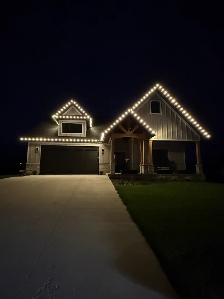 Craftsman home with warm-white roofline lights at night in Charlestown, Indiana