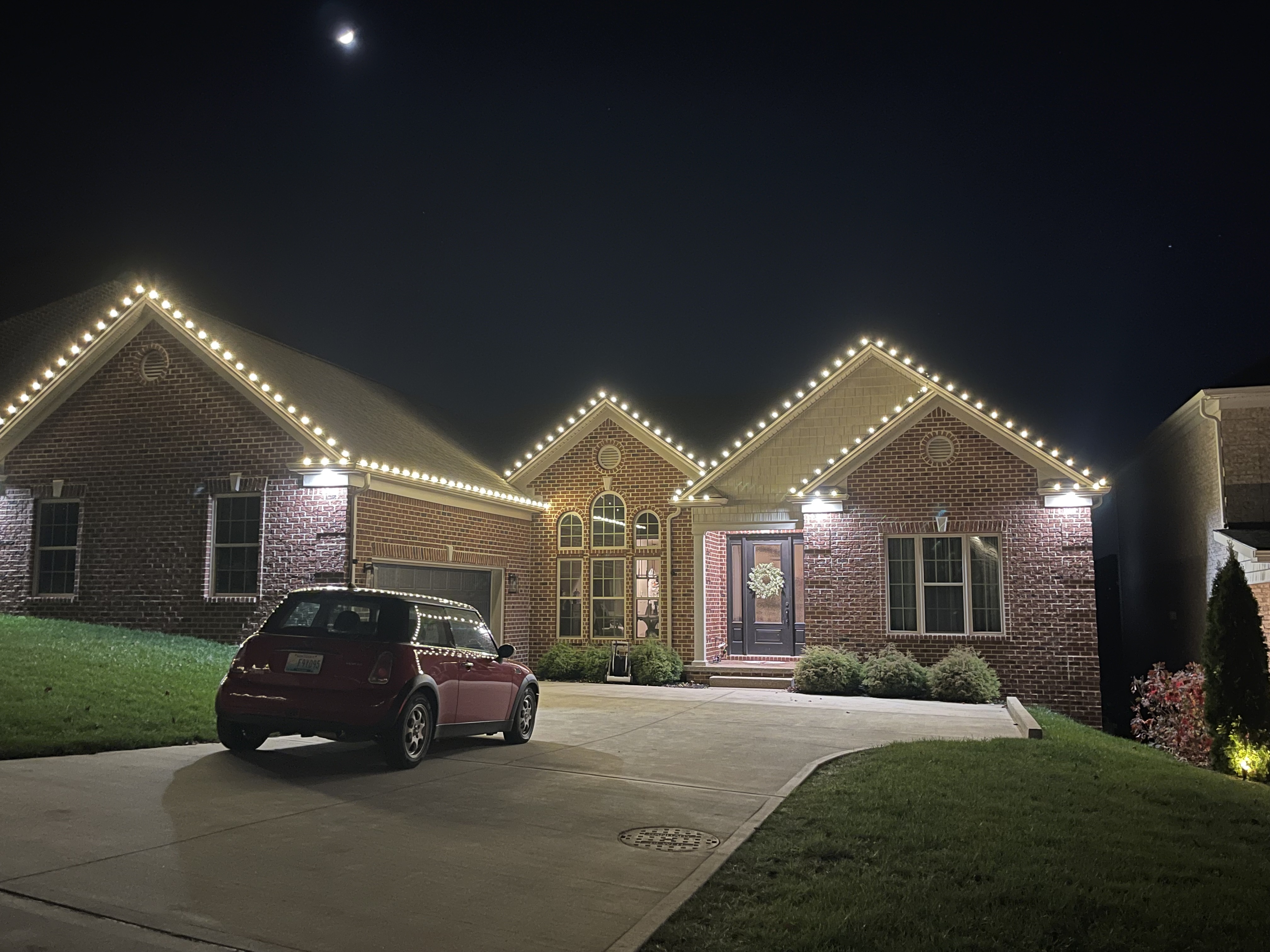 Brick ranch with warm white roofline lights