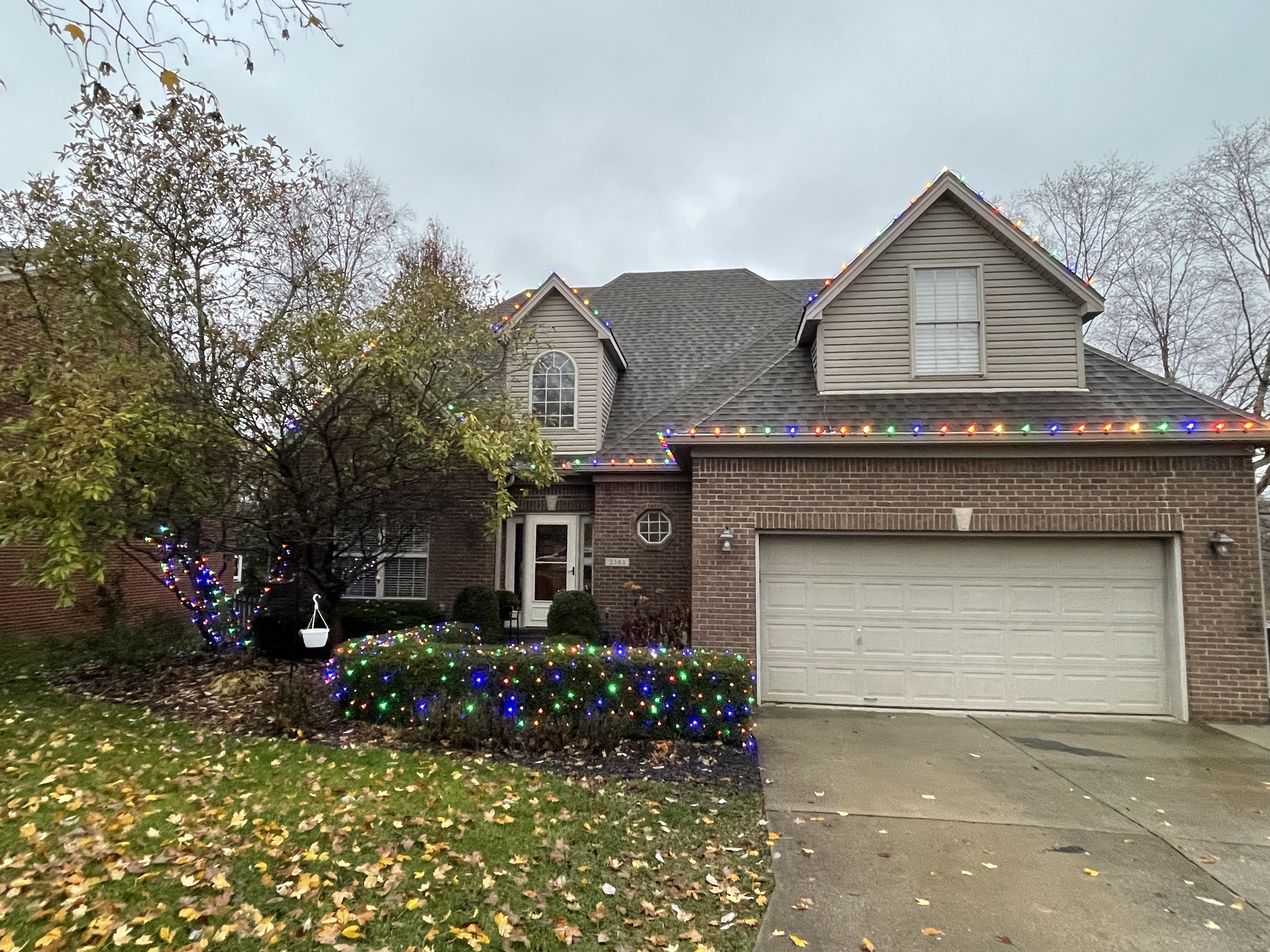 Two-story home with multicolor roofline lights